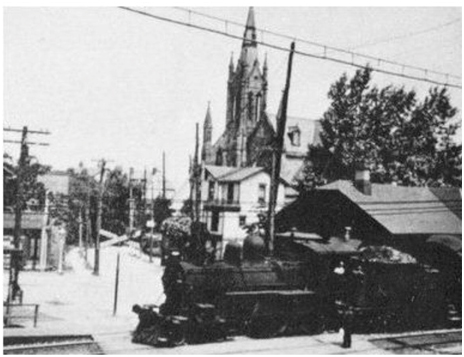 Steam trains pass through Crafton. 1906 St. Philip Church in background.